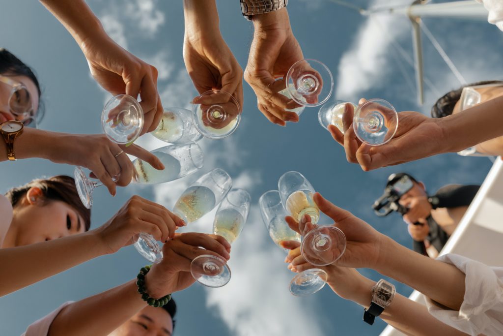 people toasting champagne from below