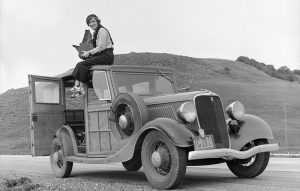 photo of Dorothea Lange on top of a car, taken by Rondal Partridge