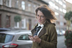 woman looking at mobile phone in city