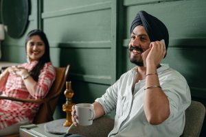 happy couple with man on mobile phone