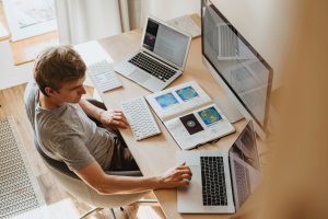 guy working at multiple computers